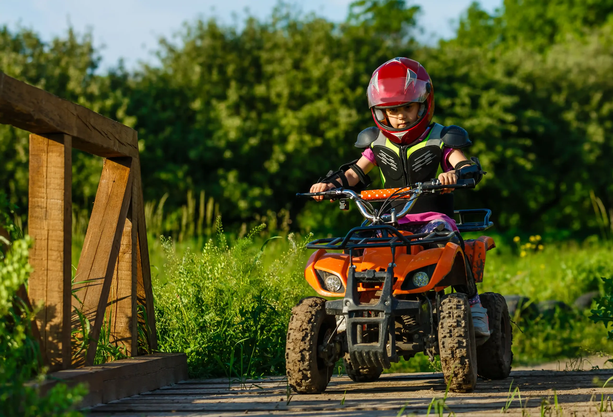 Driving road legal kids quad bike across bridge