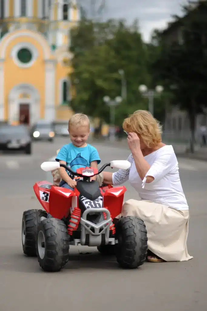 Small child riding electric quad bike